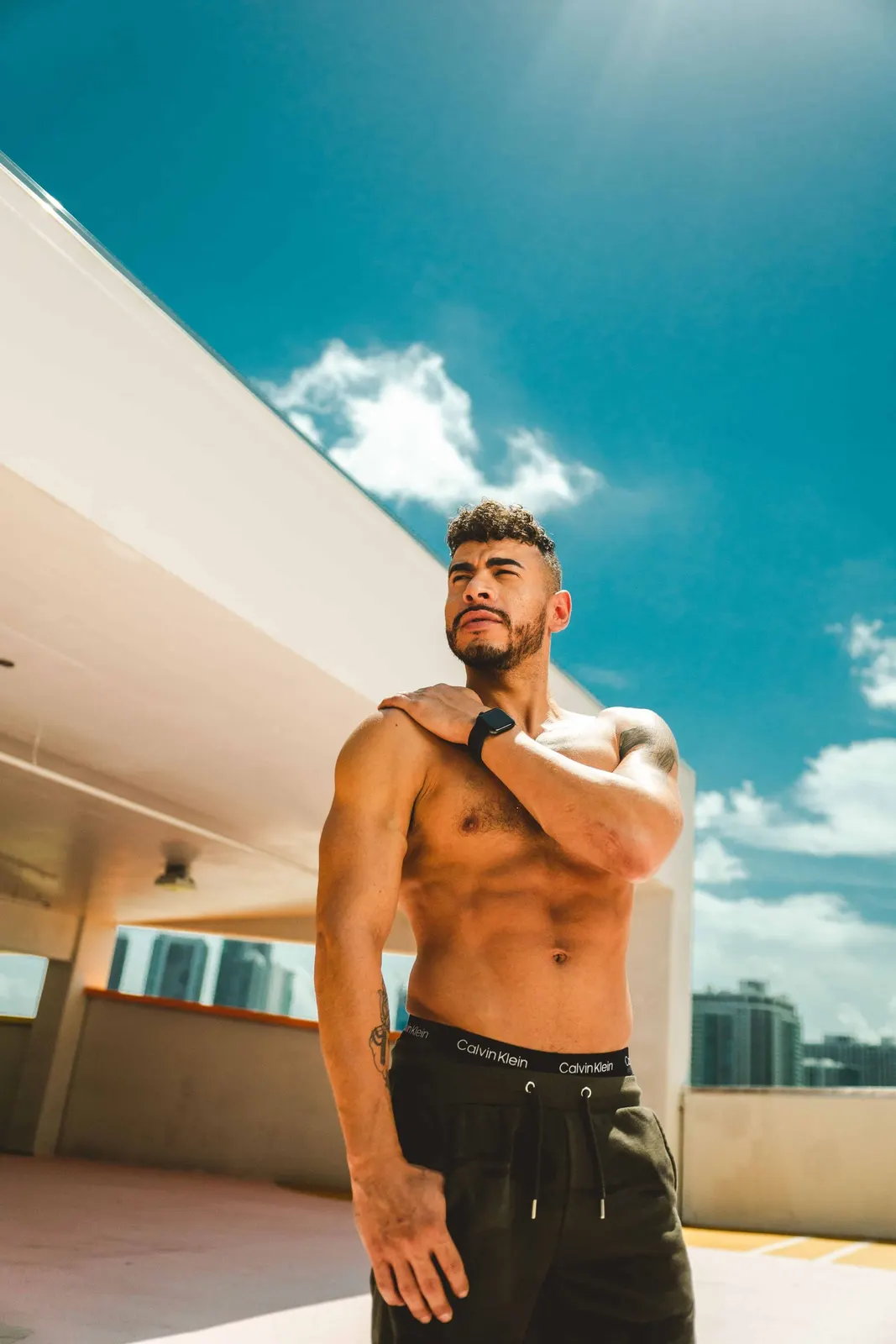 Man standing outdoors in a sleeveless shirt